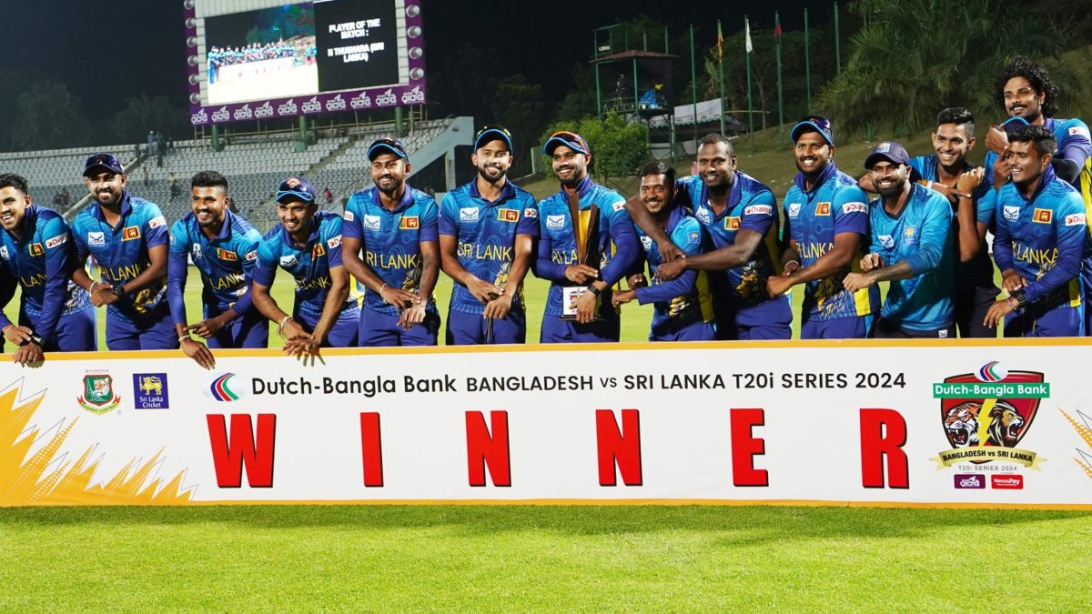 The Sri Lankan players point at their wrists while posing with the trophy won at the end of the T20I series against Bangladesh. Image credit: X/@OfficialSLC The Sri Lankan players point at their wrists while posing with the trophy won at the end of the T20I series against Bangladesh. Image credit: X/@OfficialSLC
