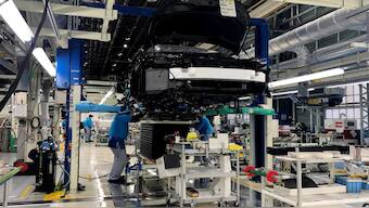 Workers install the fuel cell power system in a Toyota Mirai at a Toyota Motor Corp. factory in Toyota in Aichi Prefecture, Japan. Reuters File