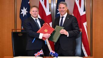 Secretary of State for Defence of the United Kingdom Grant Shapps (L) and Australian Defence Minister Richard Marles exchange Defence Treaty documents during a meeting at Parliament House in Canberra, March 21, 2024.- Reuters