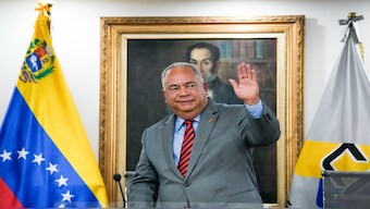 National Electoral Council (CNE) President Elvis Hidrobo Amoroso waves to the press at the National Electoral Council headquarters in Caracas, Venezuela. AP