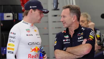 Red Bull team principal Christian Horner (R) talks with driver Max Verstappen (L) during the qualifying session ahead of the Saudi Arabian Grand Prix. AP