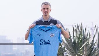Mumbai City FC's new signing Jakub Vojtus poses for a picture with the team's jersey. Image: Mumbai City FC 