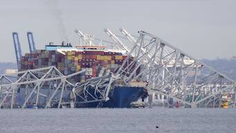 A container ship rests against wreckage of the Francis Scott Key Bridge on Tuesday,  as seen from Pasadena. The ship rammed into the major bridge in Baltimore early Tuesday, causing it to collapse in a matter of seconds. AP