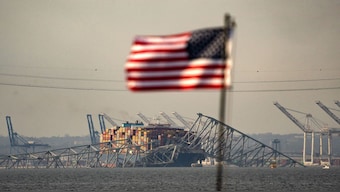 Part of the steel frame of the Francis Scott Key Bridge sits on top of the container ship Dali after the bridge collapsed in Baltimore. The bridge collapsed early 26 March after being struck by the Singapore-flagged Dali container ship, sending multiple vehicles and people plunging into the frigid harbour below. AFP