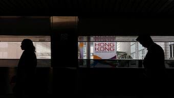 Pedestrians walk past a banner promoting Hong Kong on a footbridge in Hong Kong. Hong Kong's 90-seat legislature unanimously passed the new national security law, commonly known as Article 23. File image/Reuters