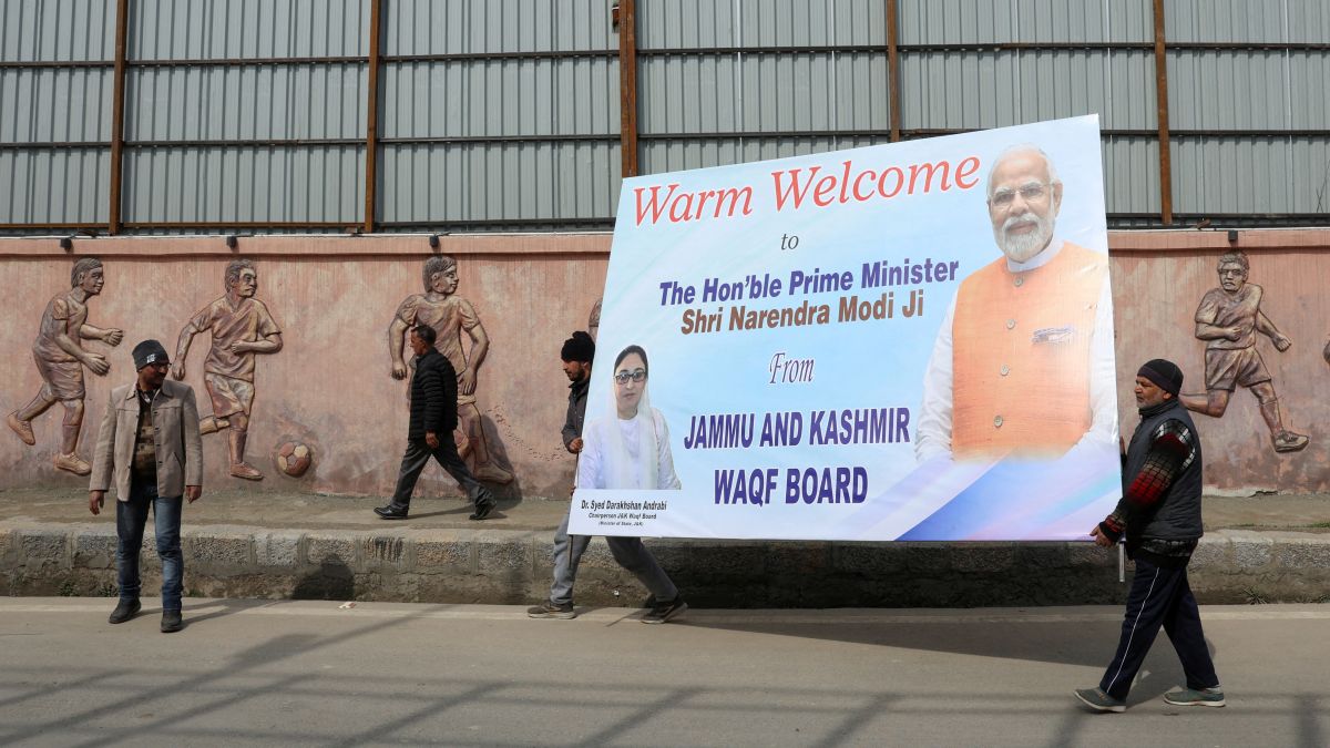 People carry a hoarding board outside the Bakshi stadium a day ahead of Prime Minister Narendra Modi's visit, in Srinagar. Reuters People carry a hoarding board outside the Bakshi stadium a day ahead of Prime Minister Narendra Modi's visit, in Srinagar. Reuters