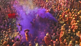 Villagers from Barsana and Nandgaon smeared with colours play Lathmar Holi at Nandagram temple in Nandgoan village in Uttar Pradesh. AP