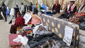 Sonam Wangchuk, lying under blankets, is surrounded by supporters during hunger strike  seeking protected status for the region’s people, land and ecology in Leh. AP