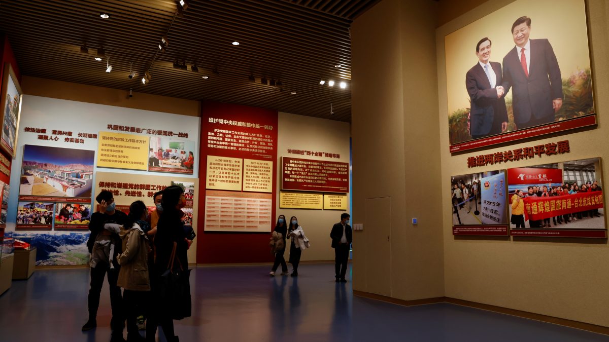 Visitors stand near an image of Chinese President Xi Jinping shaking hands with former Taiwan president Ma Ying-jeou, at the Museum of the Communist Party of China in Beijing, China, November 11, 2021. REUTERS/Carlos Garcia Rawlins Visitors stand near an image of Chinese President Xi Jinping shaking hands with former Taiwan president Ma Ying-jeou, at the Museum of the Communist Party of China in Beijing, China, November 11, 2021. REUTERS/Carlos Garcia Rawlins