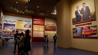 Visitors stand near an image of Chinese President Xi Jinping shaking hands with former Taiwan president Ma Ying-jeou, at the Museum of the Communist Party of China in Beijing, China, November 11, 2021. REUTERS/Carlos Garcia Rawlins