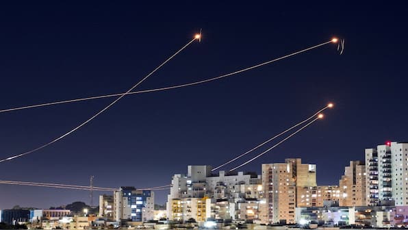 Hezbollah fires dozens of rockets into Israel amid threat of Iran's imminent attack