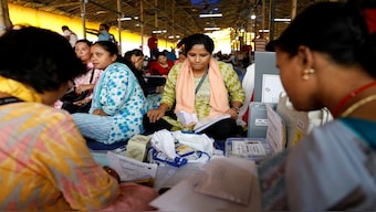 Polling officials sort papers after collecting election materials at a distribution centre, ahead of the first phase of India's general election, in Alipurduar district in West Bengal, 18 April 2024. Reuters 