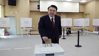 South Korean president Yoon Suk Yeol casts his early vote at a polling station in Busan, South Korea. AP