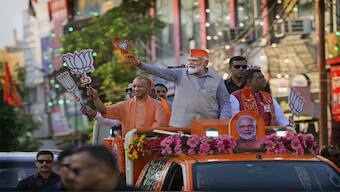 PM Narendra Modi and UP CM Yogi Adityanath ride in an open vehicle as they campaign for Bharatiya Janata Party (BJP) for the upcoming parliamentary elections in Ghaziabad, 6 April 2024. AP File Photo