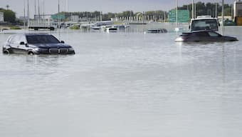 Vehicles sit abandoned in floodwater covering a major road in Dubai, United Arab Emirates. AP
