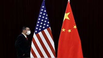 A man walks past the national flags of China and the US before a meeting between China's Vice Premier He Lifeng and US Treasury Secretary Janet Yellen at the Guangdong Zhudao Guest House, in Guangzhou, Guangdong province, China, on 6 April, 2024. Reuters File