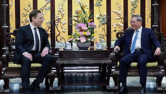 Tesla founder CEO Elon Musk, with Chinese Premier Li Qiang in Beijing. Image Credit: AP

