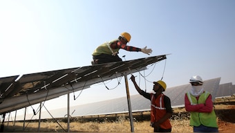 (File) Workers install solar panels at the Pavagada Solar Park 175 kilometres north of Bengaluru. AP