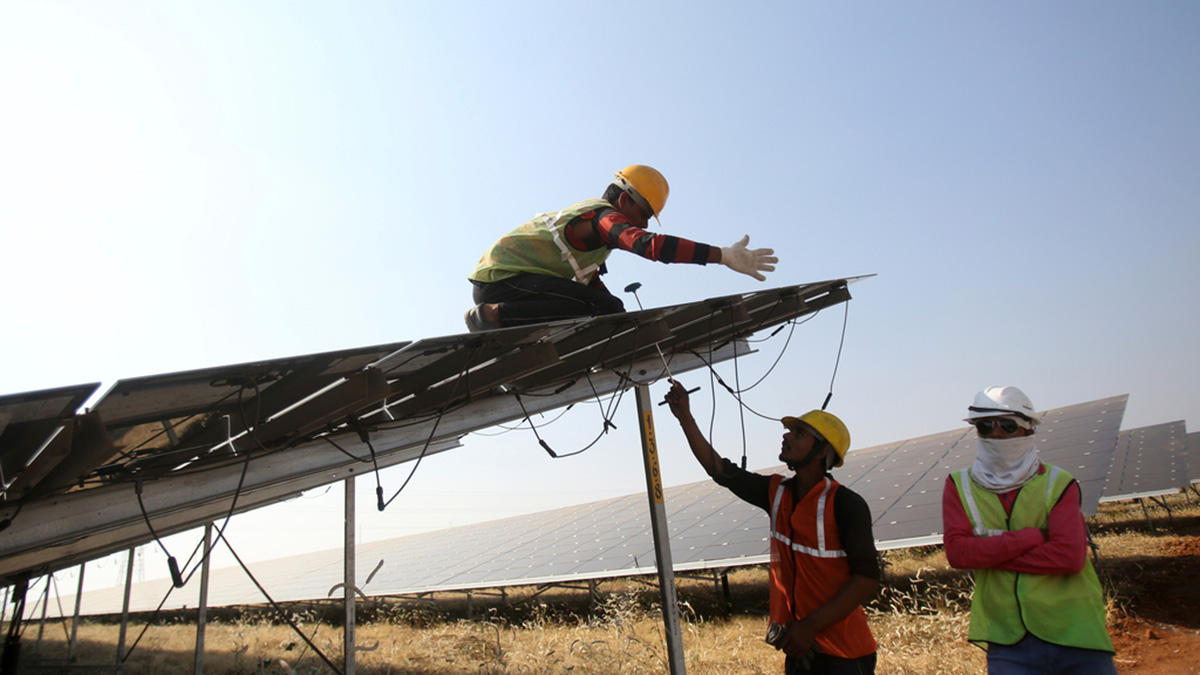 (File) Workers install solar panels at the Pavagada Solar Park 175 kilometres north of Bengaluru. AP (File) Workers install solar panels at the Pavagada Solar Park 175 kilometres north of Bengaluru. AP