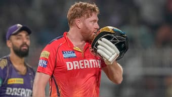 Punjab Kings opener Jonny Bairstow kisses his helmet in celebration after completing his century in just 45 balls against Kolkata Knight Riders in Kolkata. AP