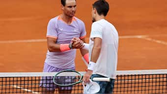 Rafael Nadal and Pedro Cachin at the net after their match at the Madrid Open. Reuters