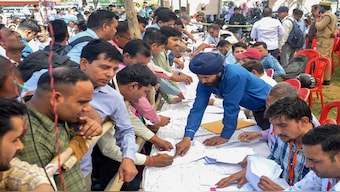 Polling officials collect EVMs and other election material at a distribution centre ahead of the first phase of voting for Lok Sabha elections, in Moradabad. PTI