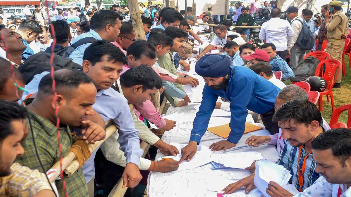 Polling officials collect EVMs and other election material at a distribution centre ahead of the first phase of voting for Lok Sabha elections, in Moradabad. PTI Polling officials collect EVMs and other election material at a distribution centre ahead of the first phase of voting for Lok Sabha elections, in Moradabad. PTI