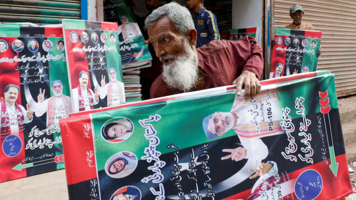 A worker carries campaign posters of a political party to decorate the area, ahead of general elections, in Karachi, Pakistan January 23, 2024. REUTERS. A worker carries campaign posters of a political party to decorate the area, ahead of general elections, in Karachi, Pakistan January 23, 2024. REUTERS.