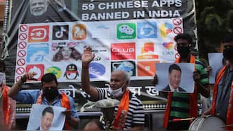 Activists shout slogans against Chinese President Xi Jinping next to a banner showing the logos of TikTok and other Chinese apps banned in India during a protest in Jammu. File image/AP