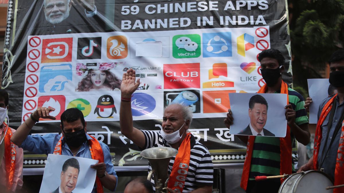 Activists shout slogans against Chinese President Xi Jinping next to a banner showing the logos of TikTok and other Chinese apps banned in India during a protest in Jammu. File image/AP Activists shout slogans against Chinese President Xi Jinping next to a banner showing the logos of TikTok and other Chinese apps banned in India during a protest in Jammu. File image/AP
