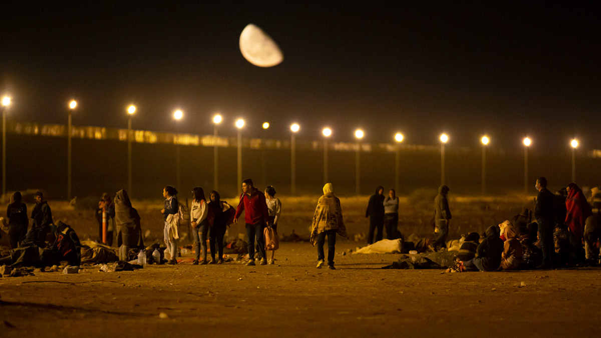 (File) Migrants arrive at a gate in the border fence after crossing from Ciudad Juarez, Mexico into El Paso, Texas, in the early hours on 11 May, 2023. AP (File) Migrants arrive at a gate in the border fence after crossing from Ciudad Juarez, Mexico into El Paso, Texas, in the early hours on 11 May, 2023. AP
