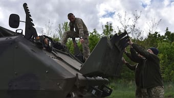 Ukrainian servicemen with the 65th Brigade open the engine doors on their armoured vehicle as they prepare for the next operation in Zaporizhzhia region, Ukraine on 21 April, 2024. AP