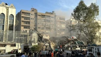 Emergency and security personnel gather at the site of strikes which hit a building adjacent to the Iranian embassy in Syria's capital Damascus, on April 1, 2024. AFP