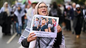 A person holding a placard picturing Australian aid worker Zomi Frankcom marches to the Parliament of Victoria during a a pro-Palestinian demonstration. Reuters