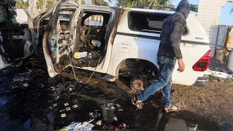 A Palestinian inspects a vehicle where employees from the World Central Kitchen (WCK), including foreigners, were killed in an Israeli airstrike. Reuters
