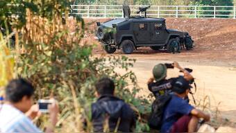 Thai soldiers and members of the media take cover near the 2nd Thailand-Myanmar Friendship Bridge during fighting on the Myanmar side between the Karen National Liberation Army (KNLA) and Myanmar's troops, which continues near the Thailand-Myanmar border, in Mae Sot, Tak Province, Thailand, April 20, 2024. REUTERS