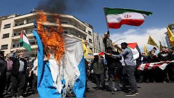 Iranians burn an Israeli flag following a suspected Israeli airstrike on the Iranian embassy complex in the Syrian capital Damascus, in Tehran. Iran has vowed action against Israel for the strike, raising fears of an escalation. File image/Reuters