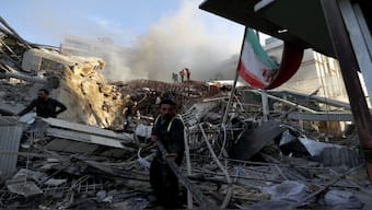 Emergency services work at a building hit by an air strike in Damascus, Syria.  Iran and Syria claim that Israeli carried out the airstrike that demolished Iran’s consulate in Damascus, killing two Iranian generals and five officers. AP
