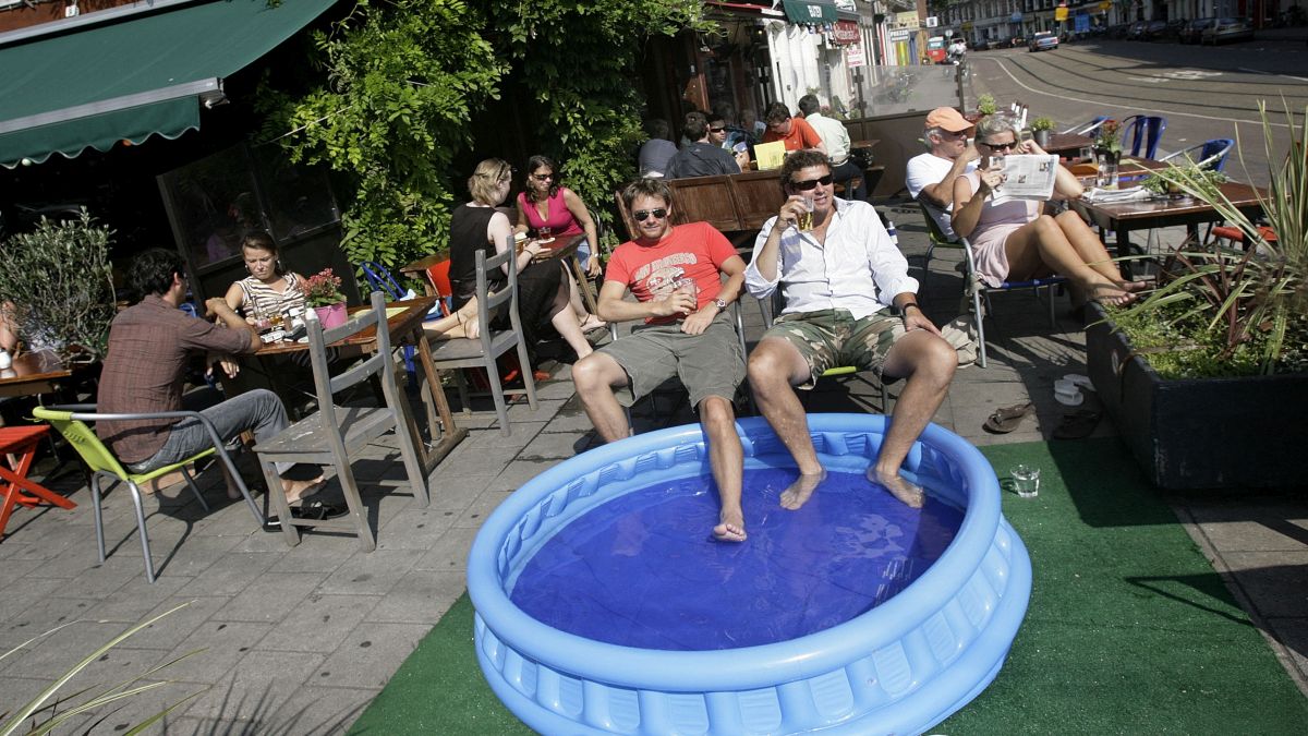 People enjoy the sun, a beer and a cold footbath at cafe in Amsterdam. Twenty-six per cent of people in the country sit for more than eight and a half hours per day, says a research. File photo/AFP People enjoy the sun, a beer and a cold footbath at cafe in Amsterdam. Twenty-six per cent of people in the country sit for more than eight and a half hours per day, says a research. File photo/AFP