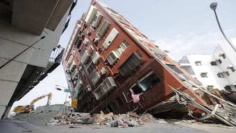 Debris surrounds a titled building a day after a powerful earthquake struck, in Hualien City, eastern Taiwan. Nine people have died and over 900 people have been injured but experts say that the island did not experience the scale of destruction that others did from similar temblors. AP