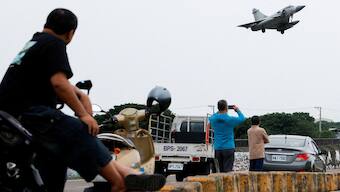 People look at a Taiwan Air Force Mirage 2000-5 aircraft as it prepares to land at Hsinchu Air Base in Hsinchu,. Reuters
