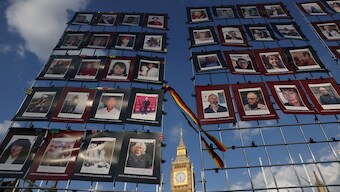 Images of victims of the contaminated blood scandal are displayed during a vigil to remember those that lost their lives. The Infected Blood Inquiry said the authorities failed victims 'not once but repeatedly.' Reuters