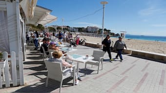 People enjoy the sunny weather on a terrace bar on Magaluf beach, on the Balearic island of Mallorca, Spain. Reuters
