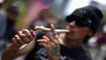 A person lights a joint, as marijuana enthusiasts gather to mark the informal annual cannabis holiday 4/20 in Mexico City. Currently, marijuana is classified as a ‘Schedule I’ drug, alongside heroin and LSD. File image/Reuters 