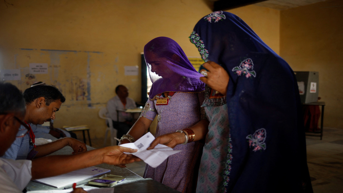 Women collect their voter slip from polling officers before casting their vote at a polling station during the second phase of the general elections, in Barmer, Rajasthan, on 26 April 2024. Reuters File Photo Women collect their voter slip from polling officers before casting their vote at a polling station during the second phase of the general elections, in Barmer, Rajasthan, on 26 April 2024. Reuters File Photo