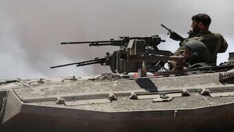 Israeli soldiers sit in a tank near the Israel-Gaza border, amid the ongoing conflict between Israel and the Palestinian Islamist group Hamas, in Israel, May 16, 2024. REUTERS/Shannon Stapleton