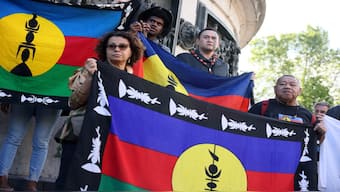 Demonstrators hold Kanak and Socialist National Liberation Front (FLNKS) flags during a gathering in Paris. AP