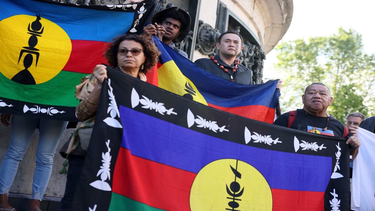 Demonstrators hold Kanak and Socialist National Liberation Front (FLNKS) flags during a gathering in Paris. AP Demonstrators hold Kanak and Socialist National Liberation Front (FLNKS) flags during a gathering in Paris. AP