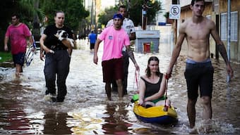 A woman is rescued from an area flooded by heavy rains in Porto Alegre, Rio Grande do Sul state, Brazil. AP