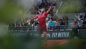 Novak Djokovic serves during his first round match at the French Open in Paris. AP